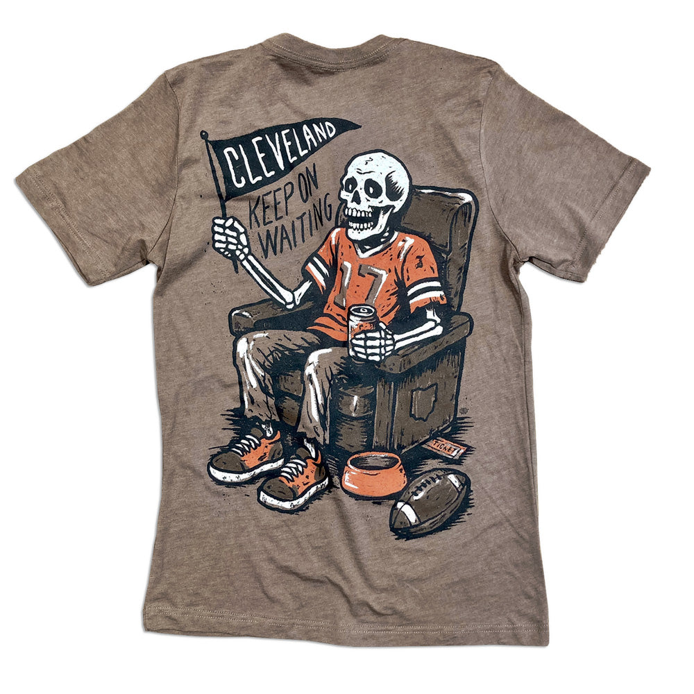 Brown t-shirt with a skeleton wearing a sports jersey and holding a flag, on a white background